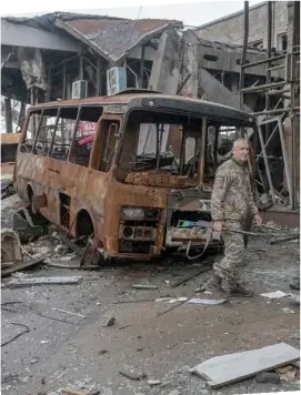  ?? BULENT KILIC/AFP ?? Devastatio­n A Ukrainian soldier walks in front of a destroyed building in the village of Chornobaiv­ka, outskirts of Kherson.