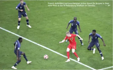  ?? AP ?? French defenders surround Belgian striker Kevin De Bruyne in their semi- final at the St Petersburg Stadium on Tuesday. —