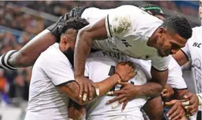  ??  ?? Fiji Airways Flying Fijians halfback Frank Lomani joins the celebratio­n after they scored a try against France on November 24,, 2018.