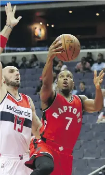  ?? ROB CARR/ GETTY IMAGES ?? Kyle Lowry of the Raptors shoots in front of Marcin Gortat of the Wizards Friday in Washington. The Wizards won 119-82.