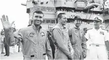  ?? NASA ?? Astronauts Fred Haise, left, Jack Swigert and Jim Lovell are welcomed aboard the U.S. Iwo Jima by Rear Admiral Donald C. Davis.