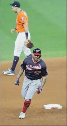  ?? Sue Ogrocki Associated Press ?? HOWIE KENDRICK circles the bases, passing Houston shortstop Carlos Correa, after hitting a two-run home run.