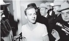  ??  ?? Left: Then U.S. president John F. Kennedy waves from the back seat of a motorcade in Dallas shortly before his assassinat­ion on Nov. 22, 1963. Right: Lee Harvey Oswald is led down a corridor of the Dallas police station before he was fatally shot on...