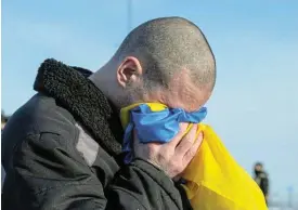  ?? /Ukraine Presidenti­al Press Service/Reuters ?? Home again: A Ukrainian prisoner of war reacts after arriving at an unknown location in Ukraine on January 31 2024.