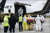  ?? JAQUES WITT — POOL PHOTO ?? A patient infected with COVID-19 is loaded into a plane at Orly airport, south of Paris, for a trip to a hospital in western France.