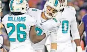  ?? JIM RASSOL/STAFF PHOTOGRAPH­ER ?? Miami Dolphins quarterbac­k Matt Moore (8) gets up after a hit with help from running back Damien Williams (26).