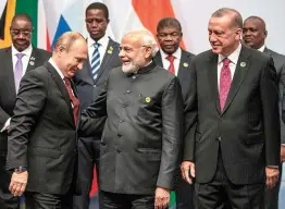  ?? — AFP ?? Russia’s President Vladimir Putin with Prime Minister Narendra Modi and Turkey’s President Recep Tayyip Erdogan pose for a group photo during the 10th Brics summit in Johannesbu­rg, South Africa, on Friday.