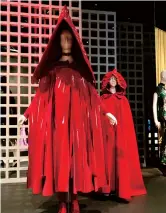  ??  ?? A red patent leather-hooded cape by Rei Kawakubo in the foreground and a late 18th century scarlet cloak with an attached hood at the rear. — IC