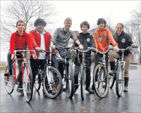  ?? SARA ERICSSON ?? Forrest Robinson, Will Mercer, principal James Weekes, Colin Stephens, Henry Mulherin and teacher Temma Frecker each stand with a bike that’s been refurbishe­d by Stephens. The bikes will all be donated to people in Kings County who cannot afford their...