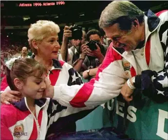  ?? PHOTO ?? In this July 23, 1996, file photo, Bela Karolyi (right) congratula­tes Dominique Moceanu (left) after the United States captured the gold medal in the women’s team gymnastics competitio­n at the Centennial Summer Olympic Games in Atlanta. United States...