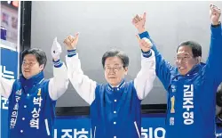  ?? BLOOMBERG ?? Lee Jae-myung, leader of the Democratic Party, centre, raises his hands with other candidates during a campaign rally in Gimpo, South Korea, on Saturday.