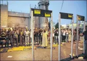  ?? MAHMOUD ILLEAN / AP ?? Palestinia­ns pray in front of mock metal detectors during a protest in Bethlehem on Sunday. Muslim leaders say Israel is trying to expand its control under the guise of security, a claim Israel denied.