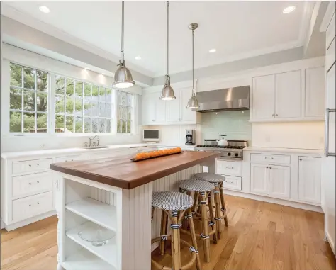  ?? PlanOmatic ?? The kitchen at 9 Milton Place in Rowayton features high-end appliances and fixtures, an island and an oversized window behind the sink.