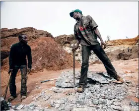  ?? ?? Men work at the mine.