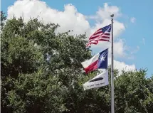  ?? Raquel Natalicchi­o/Staff file photo ?? The school board flies a “Come and Take It” flag, refusing to make a Robin Hood payment. Later, the board backed down.