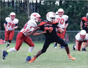  ??  ?? Saddle Ridge’s Kevin Kremb tries to hang on to LaFayette running back Jaylon Ramsey during last Thursday’s league game in south Walker County. (Photo by Scott Herpst)