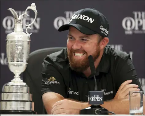  ?? PETER MORRISON — THE ASSOCIATED PRESS ?? Ireland’s Shane Lowry smiles as he sits next to the Claret Jug trophy while he attends a press conference after he won the British Open Sunday at Royal Portrush in Northern Ireland.