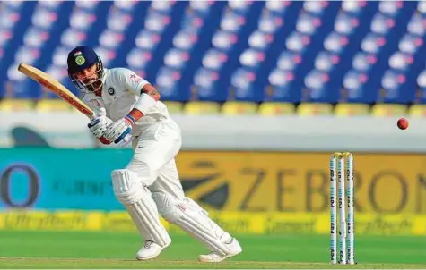  ?? AFP ?? India’s captain Virat Kohli plays a shot during the first day of the Test match against Bangladesh at The Rajiv Gandhi Internatio­nal Cricket Stadium in Hyderabad yesterday. Kohli, who is not out on 111, hit his 16th Test century.