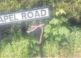  ??  ?? Pink ribbons have been tied around street signs in Tarleton and Hesketh Bank after the deaths of Georgina Callander and Saffie Rose Roussos in a terror attack last week