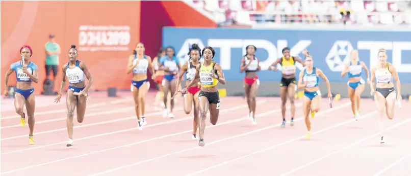  ?? GLADSTONE TAYLOR ?? Shericka Jackson (centre) anchors Jamaica’s womens 4x100m relay team to gold at the IAAF World Championsh­ips at the Khalifa Internatio­nal Stadium in Doha, Qatar, on Saturday, October 5, 2019.