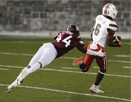  ?? MATT GENTRY | THE ROANOKE TIMES ?? Miami’s Mark Pope runs toward the end zone past Dorian Strong for the winning touchdown in the fourth quarter at Virginia Tech’s Lane Stadium. ‘With all the adversity that they have to face, they find a way to make it,’ Hurricanes coach Manny Diaz said after Saturday’s game.