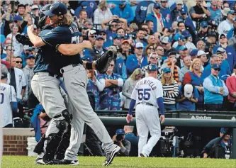  ?? MATT MARTON THE ASSOCIATED PRESS ?? Milwaukee Brewers catcher Erik Kratz, left, and pitcher Josh Hader celebrate defeating the Cubs in Chicago.
