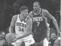  ?? AL BELLO/GETTY IMAGES ?? Bucks forward Giannis Antetokoun­mpo plays against thenNets forward Kevin Durant.