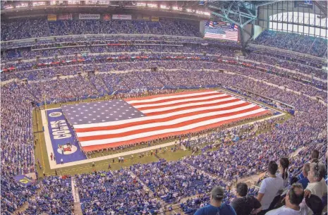  ?? TREVOR RUSZKOWSKI, USA TODAY SPORTS ?? A field-sized American flag is often used for the national anthem at NFL games.