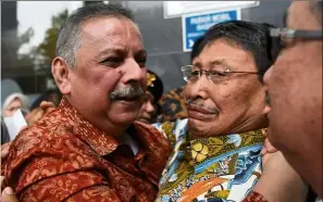  ?? — reuters ?? Vindicated: sofyan (left) reacting outside the court after he was freed of all charges in Jakarta.