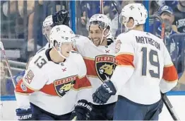  ?? CHRIS O'MEARA/AP ?? Mark Pysyk (13) is paired on defense with Mike Matheson, right. Coach Bob Boughner, known for his work with defensemen in San Jose, says the team is working on tightening up the defense, especially behind the net.