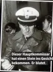  ??  ?? Dieser Hauptkommi­ssar hat einen Stein ins Gesicht bekommen. Er blutet.