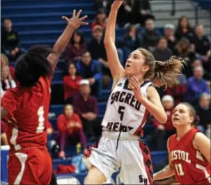  ?? BOB RAINES— DIGITAL FIRST MEDIA FILE ?? Kayleigh Doyle of Sacred Heart sends up a shot over Bristol’s Dainella McMillians in last season’s District 1 Class 2A title game. Doyle had 14 points, five assists and three steals to help the Lions claim a 63-56 win over West Chester East Thursday.