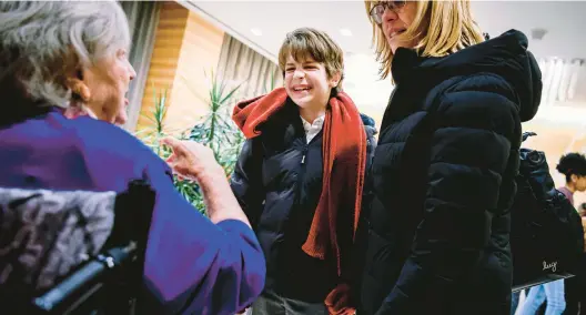  ?? NINA WESTERVELT/THE NEW YORK TIMES PHOTOS ?? Benjamin Pajak, 12, talks with a resident Nov. 30 at Inspir Carnegie Hill, a senior living community in the Manhattan borough of New York.