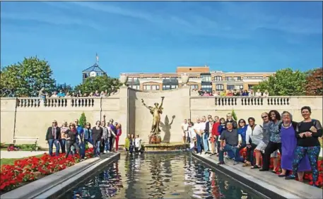  ?? PHOTO BY JAMES PICKET ?? On Sept. 17, about 90 members of the Saratoga Springs High School Class of 1976 recreated a photo at the Spirit of Life statue that was in their yearbook.