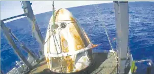  ??  ?? NASA TV This still image taken from NASA TV shows Spacex’s Crew Dragon spacecraft safely aboard the company’s recovery vessel following splashdown on March 8, 2019.