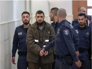  ?? (Yonatan Sindel/Flash90) ?? KHALED KOUTINEH, the Palestinia­n who carried out a deadly car-ramming attack at a French Hill bus stop in 2015, is brought to the Jerusalem District Court for sentencing yesterday.