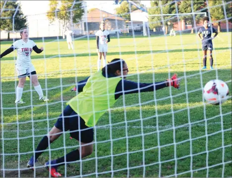  ?? Photos by Ernest A. Brown ?? Tolman junior Emily Rossi (above, left) fires a penalty shot past Shea goalie Michelle Sanchez with five minutes left in Thursday’s game to earn the Tigers a 2-1 win at McKinnon- Alves. Shea’s Yasmine Santos (16, below) battles Tolman junior Melissa...