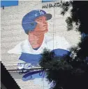  ?? ROBERT HANASHIRO/USA TODAY SPORTS ?? Artist Robert Vargas works on a mural of Shohei Ohtani on the 11-story Miyako Hotel in the Little Tokyo District of L.A. The mural will be officially unveiled on March 27, the day before the Dodgers play their first home game of the 2024 season.