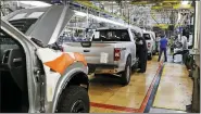  ?? ASSOCIATED PRESS FILE PHOTO ?? United Auto Workers assemblyme­n work on a 2018Ford F-150trucks being assembled at the Ford Rouge assembly plant in Dearborn in this 2018 photo.