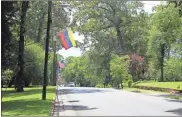  ?? Myrick / Kevin ?? Flags from around the globe are up and lining College Street in anticipati­on of the arrival of race participan­ts for the Cedartown Internatio­nal Wheelchair 5K and Road Race.