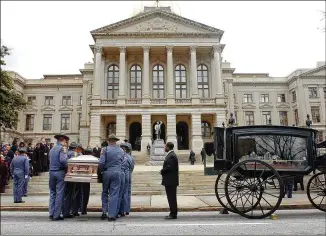  ?? AJC 2006 ?? The pinnacle for the Watkins Funeral Home came when it was chosen to handle the service of Coretta Scott King, whose casket was transporte­d in a horse-drawn carriage to the State Capitol.