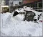  ?? BILL SIKES — THE ASSOCIATED PRESS ?? A worker clears snow from the street in Boston’s Seaport district on Friday, Jan. 5, 2018, following Thursday’s snowstorm.