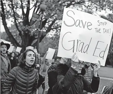  ?? [BROOKE LAVALLEY/DISPATCH] ?? Marchers at Ohio State University protest a proposal in the U.S. House to tax the stipends and tuition waivers that graduate students receive from universiti­es for their research or teaching work. The march on Monday crossed the Oval from near Thompson...