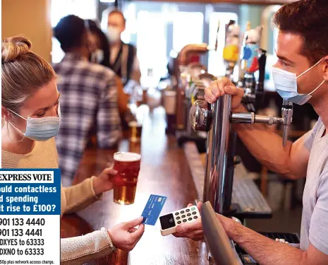  ?? ?? A woman pays for a pint in a pub with a contactles­s card