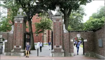  ?? CHARLES KRUPA — THE ASSOCIATED PRESS FILE ?? Pedestrian­s walk through the gates of Harvard Yard at Harvard University last August in Cambridge, Mass. Harvard and the Massachuse­tts Institute of Technology filed a federal lawsuit Wednesday, challengin­g the Trump administra­tion’s decision to bar internatio­nal students from staying in the U.S. if they take classes entirely online this fall.