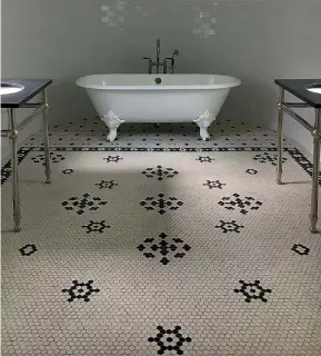  ??  ?? Blue and white mosaic tiles create different zones in this attic bathroom.