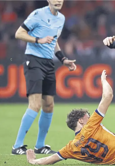  ?? ?? Scotland midfielder Scott Mctominay is tackled by Netherland­s’ Mats Wieffer during last night’s friendly. Above left, Georginio Wijnaldum celebrates scoring the hosts’ second goal and, right, Wijnaldum and Lawrence Shankland battle for the ball