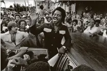  ?? DAVIDSON III / THE PALM BEACH POST JOHN H. ?? The original caption from the September 1978 story: Millionair­e singer James Brown waves to a crowd of students during his surprise visit to Twin Lakes High School in West Palm Beach.