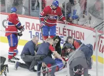  ?? JOHN KENNEY ?? P.K. Subban is tended to by the Canadiens’ medical staff after being injured in Thursday’s game against the Sabres.