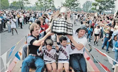  ?? UNIVERSITY OF WATERLOO LIBRARY S ?? When the Kitchener Rangers returned home following their Memorial Cup win in Hull, the streets were lined by thousands of fans savouring the city’s first major hockey championsh­ip since 1960. Mike Moher and Jeff Larmer held the cup high. The cup originally honoured Canada’s dead in First World War but in 2010 was re-dedicated to pay tribute to all of Canada’s fallen soldiers.